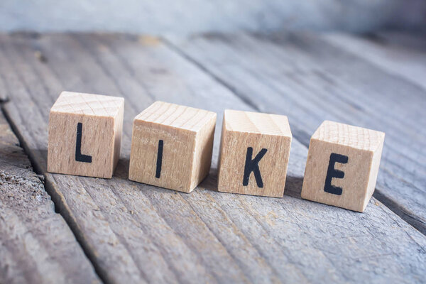 Macro Of The Word Like Formed by Wooden Blocks On a Wooden Floor
