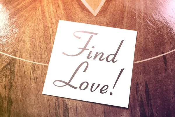 Find Love Reminder On Paper Lying On Wooden Table