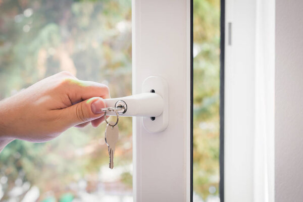 Window With A Lockable Handle And Keys Closed By A Male Hand, Childproof Window Concept