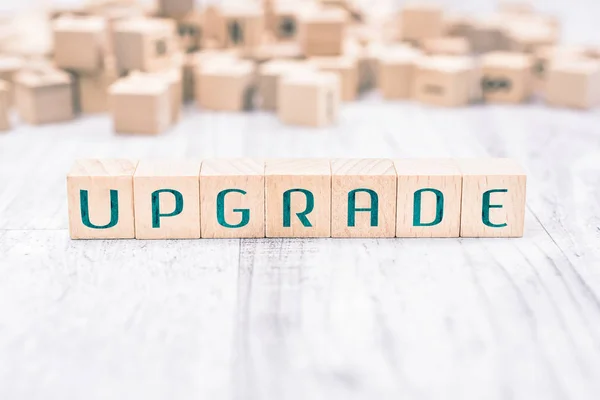 The Word Upgrade Formed By Wooden Blocks On A White Table, Reminder Concept — Stock Photo, Image