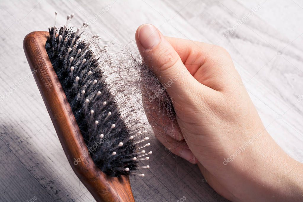 Female Hand Pulling Bunch Of Hair Out Of Brush - Alopecia Hair Loss Concept