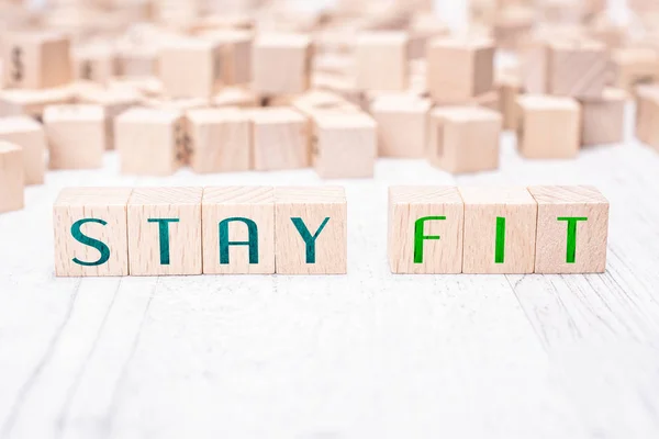 The Words Stay Fit Formed By Wooden Blocks On A White Table — Stock Photo, Image