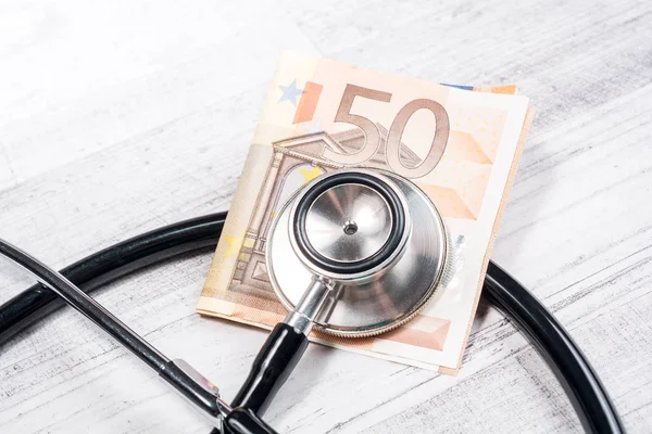 Examing A 50 Euro Bill With A Stethoscope - Checking The Financial Status Concept