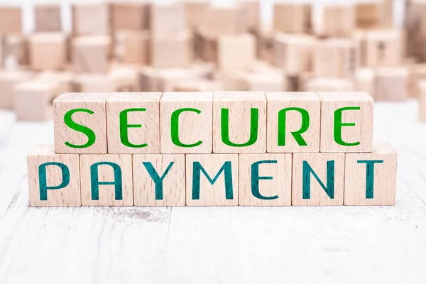 The Words Secure Payment Formed By Wooden Blocks On A White Table