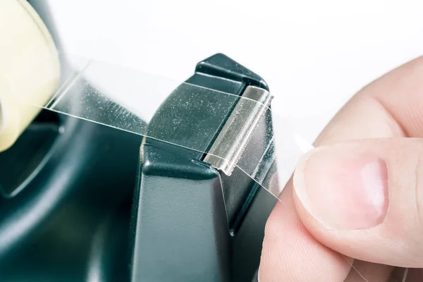 Macro Of A Male Hand Pulling Of Some Tape Of A Sellotape Holder — Stock Photo, Image