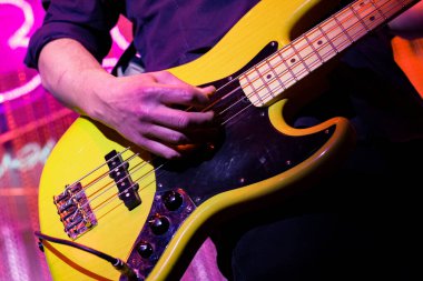 Konserde elektro gitar çalan bir adam..