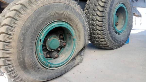close-up shot of a flat tire of a farm trailer
