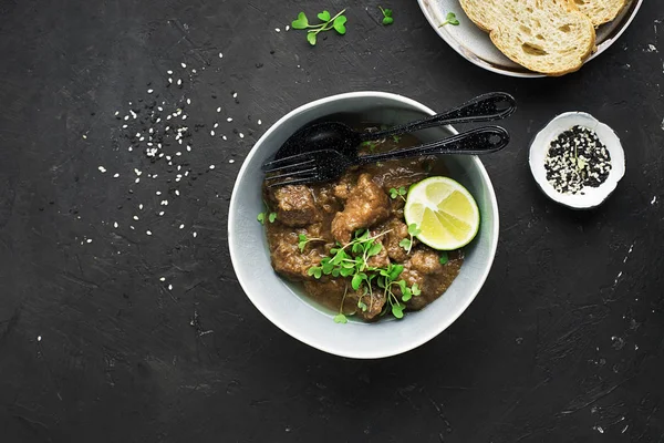 Ev yapımı Dana güveç sulu kireç ve alakart mikro yeşillik ile pilav ile servis. Üstten görünüm.