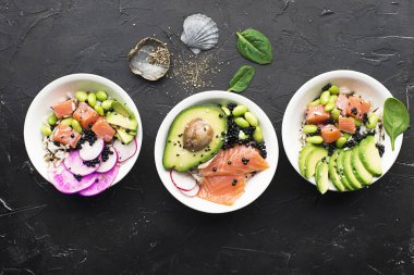 Fresh seafood recipe. gravlax salmon poke bowl with fresh prawn, brown rice, cucumber, pickled sweet onion, radish, soy beans edamame portioned with black and white sesame. Food concept poke bowl clipart