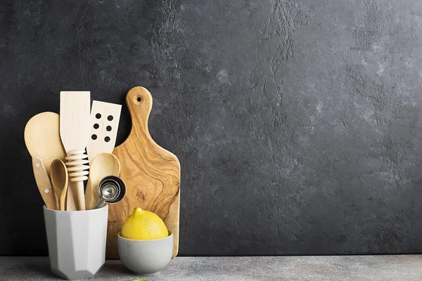 Zero waste house kitchen. Gray shelf with kitchenware, wooden toothpicks and olive cutting board. Copy space.