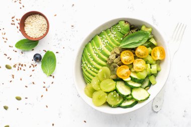 Yeşil sebze arınması salata kasesini dengeliyor. Avokadolar, salatalıklar, kiraz domatesleri, yabanmersini, kereviz, üzüm. Etsiz sulu kremalı çıtır.