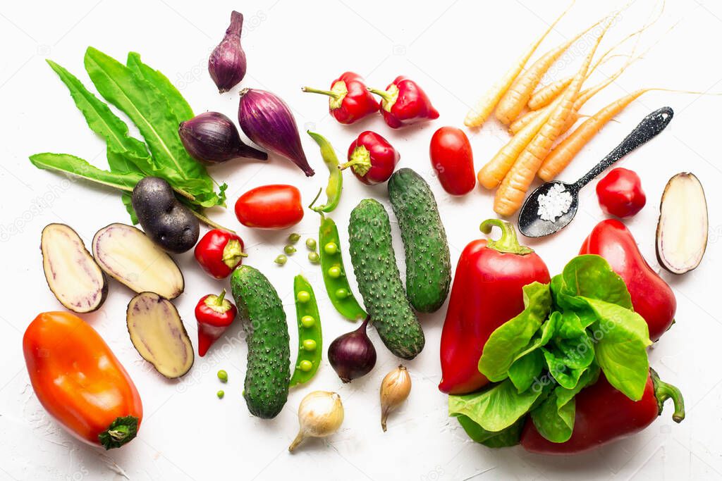 Fresh vegetables, herbs, green leafy salads on a white background. Farmers harvest organic natural products for healthy clean food at home. Top view.,