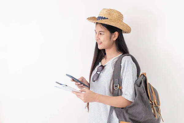 Asian woman traveler backpacker use map and mobile phone app to search for route location of place with gps on white background,Technology in lifestyle