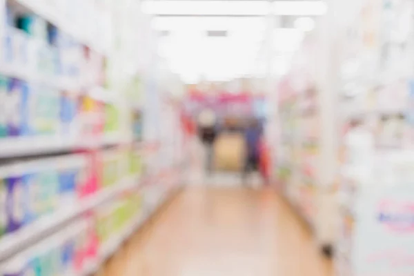 Blur background of customer shopping with shopping cart at Supermarket store product shelf with bokeh light