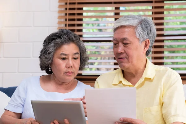 Asian senior couple  calculate retirement financial use tablet s