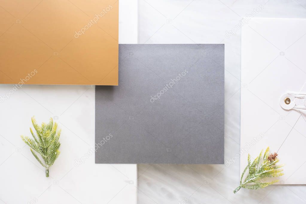 Top view of blank grey card overlap on envelop and gold card wit