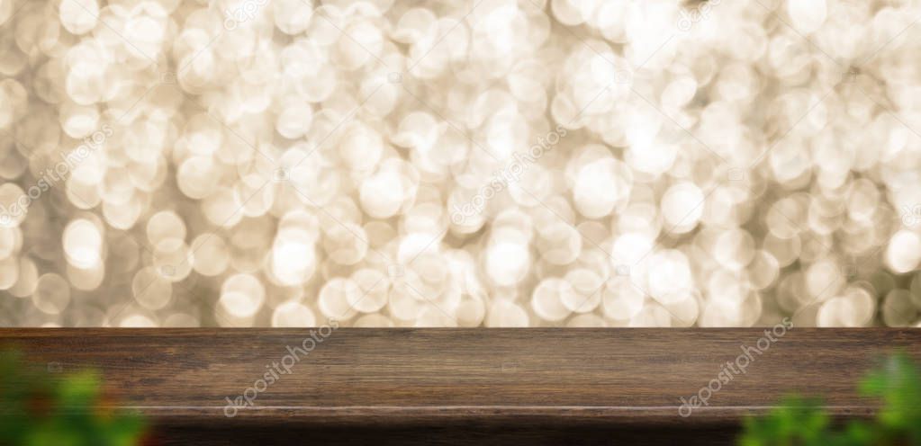 Empty old rustic dark wood table top with blur sparkling gold bo