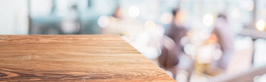 Perspective wood table with blur cafe restaurant with people din