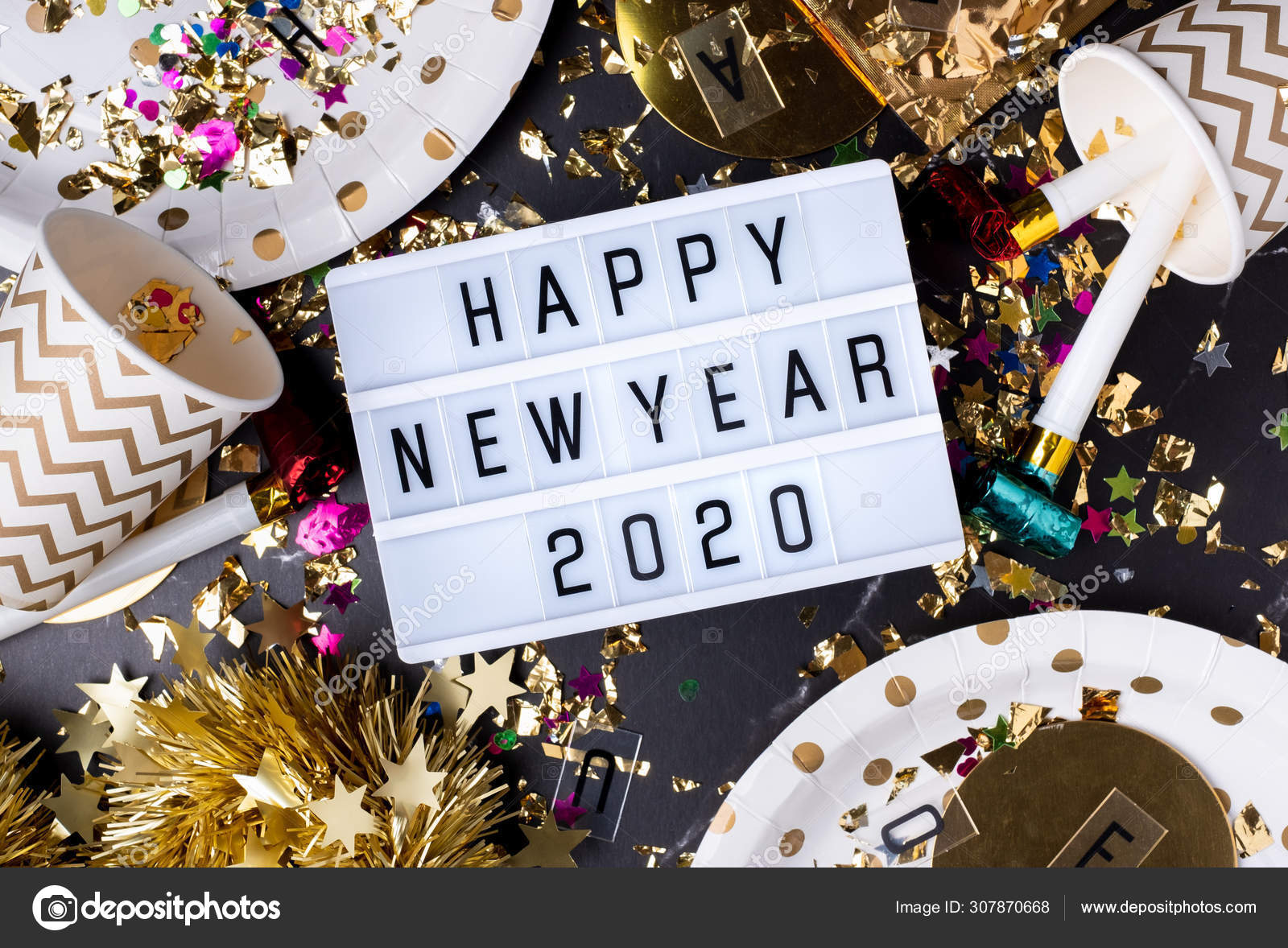Happy New Year 2020 On Light Box With Party Cup Party Blower Tin