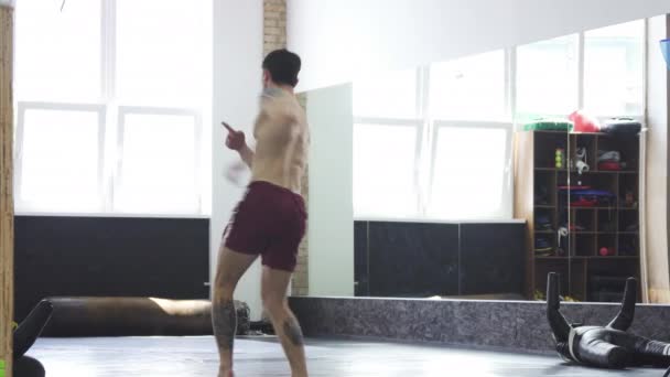 Полнометражный снимок разорванного бойца Мма, практикующего хич-кики в спортзале — стоковое видео