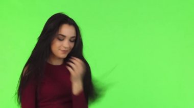 Genç neşeli güzel kız seductively yeşil arka plan üzerinde poz