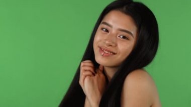 Şirin ve mutlu yeşil backgorund üzerinde arıyorsunuz çarpıcı güzel Asyalı kadın