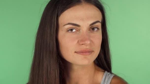 Happy young woman smiling, putting flower in her hair — Stock Video