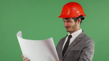 Mutlu mimar sevinçle gülümseyen onun planları incelenmesi