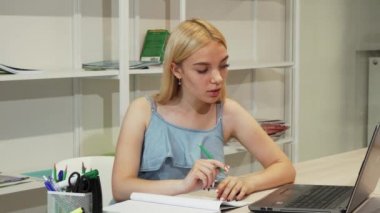 Dizüstü bilgisayar kullanarak onun ödev çekici kız öğrenci