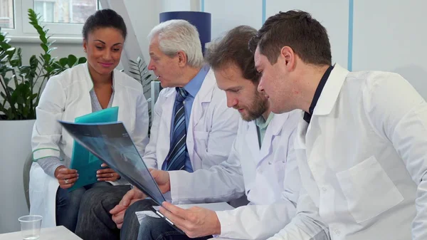 Equipo médico discute imagen de rayos X —  Fotos de Stock