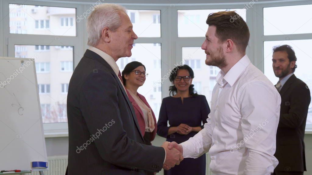 Businessmen shakes hands at the office