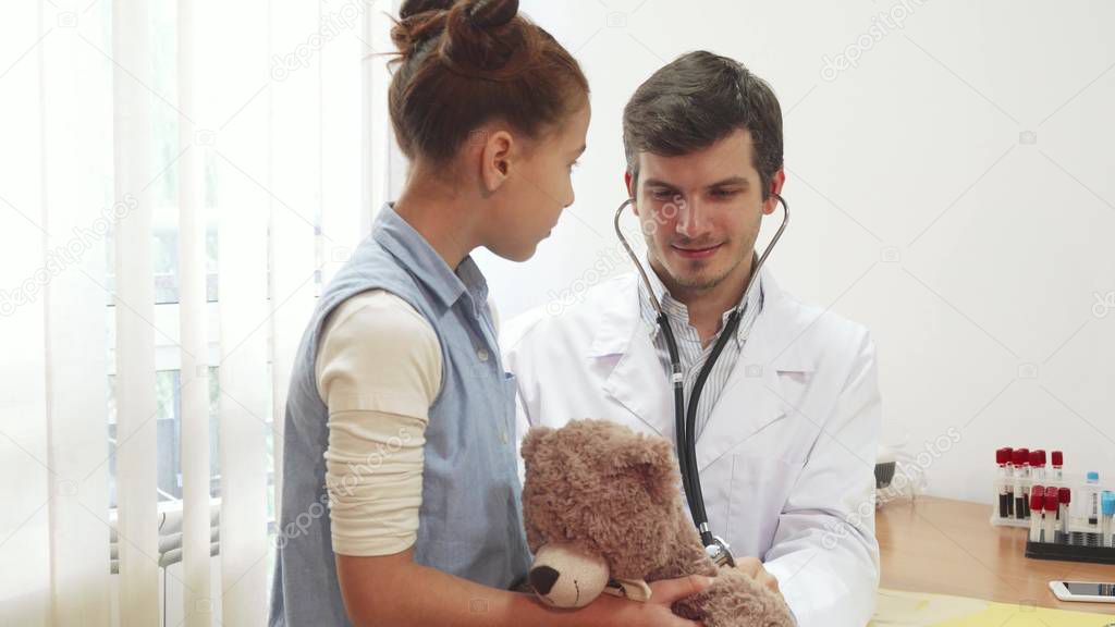 The good doctor is listening through a stethoscope girl s soft toy
