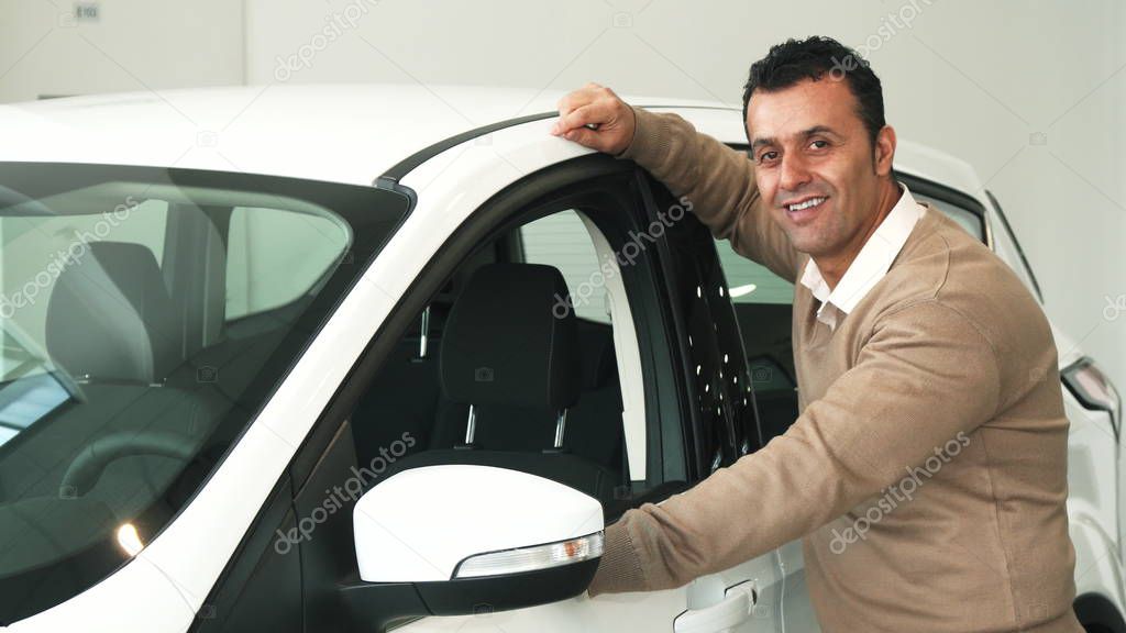 The attentive man went to the window of the car and examined the cars interior