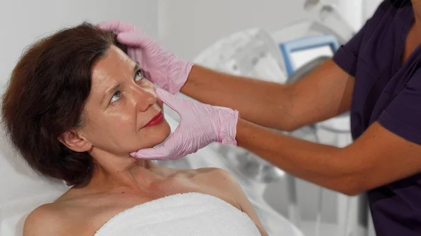 Orta yaşlı kadın dermatolog tarafından muayene cildine Başlarken