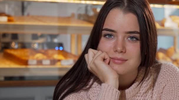 Lovely young woman smiling to the camera, drinking coffee in the morning — Stock Video