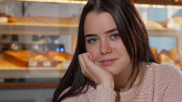 Preciosa joven sonriendo a la cámara, tomando café por la mañana —  Fotos de Stock