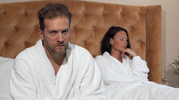 Зрелый мужчина смотрит в камеру после ссоры с женой
