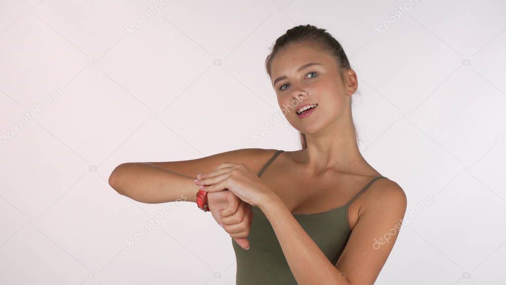 Beautiful athletic woman checking time on her sports watch