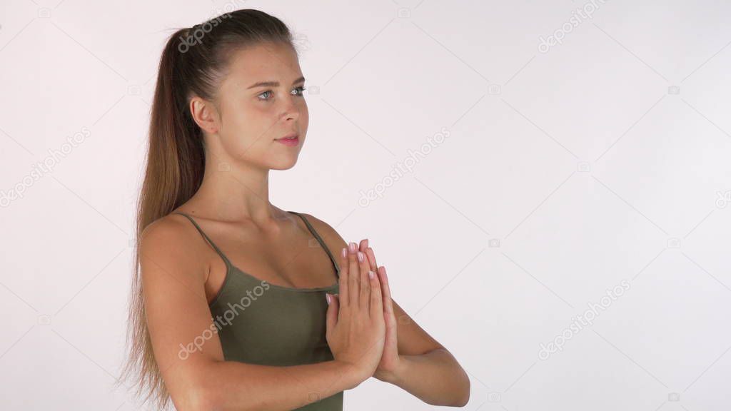 Beautiful healthy woman looking to the camera, preparing for meditation