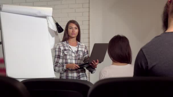 Красива бізнес-леді використовує свій ноутбук під час конференції — стокове відео