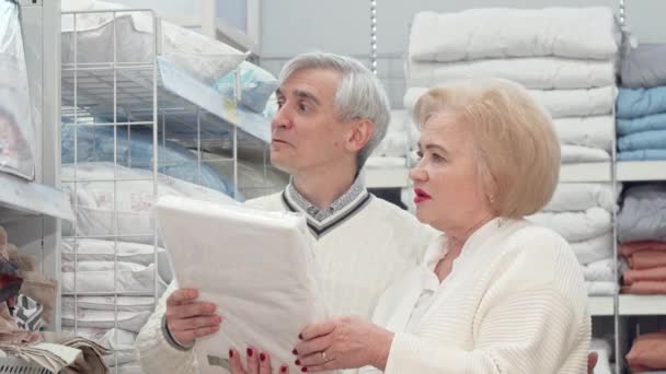 Happy elderly couple laughing, talking while shopping for home goods — Stock Video