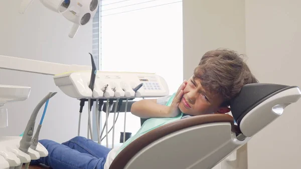 Little boy with toothache looking desperately to the camera — Stock Photo, Image