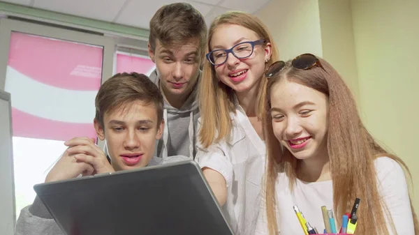 노트북을 사용하여 함께 공부하는 십대 그룹의 로우 앵글 크롭 샷 — 스톡 사진