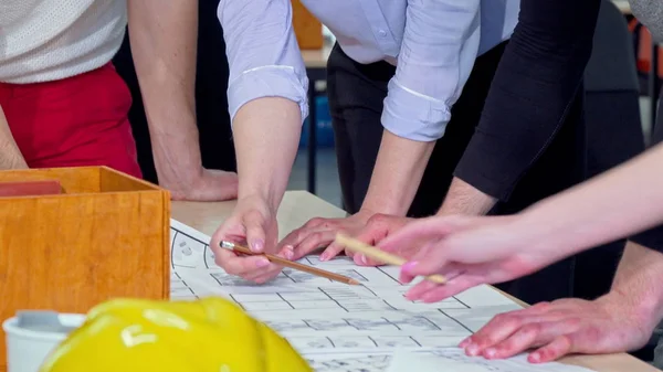 Sliding shot of architects discussing architectural blueprint — Stock Photo, Image