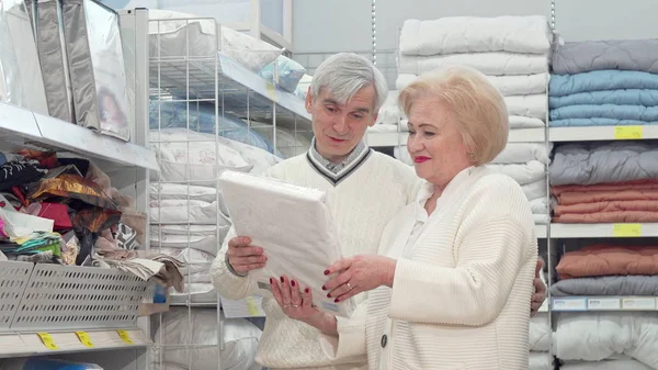 Mobilya mağazasında çarşaf için Lovely yaşlı çift alışveriş