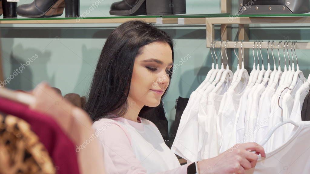 Attractive young woman enjoying shopping for new clothes