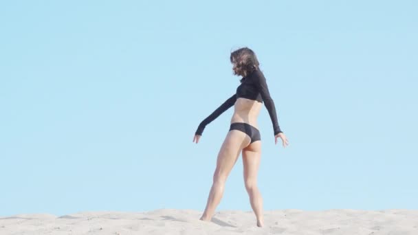 Beautiful flexible female dancer performing on sand in the desert — Stock Video