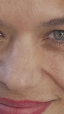 A captivating close-up of a cheerful woman with sparkling eyes, laughing joyfully at the camera, her radiant smile illuminating the urban backdrop. This charming mature female embodies confidence and warmth, showcasing the beauty of diversity in a