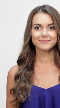 A joyful young woman playfully covers her sisters eyes, her laughter echoing in the air, set against a pristine white backdrop. This heartwarming scene captures the essence of sibling love and the thrill of surprise, radiating pure happiness and