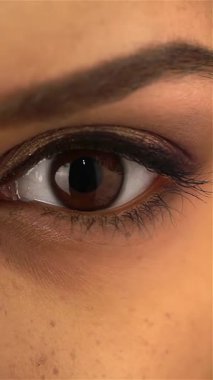 This stunning close-up captures the enchanting dark eyes of a young African-American girl, radiating warmth and emotion. Her expressive gaze, framed by flawless skin and delicate features, invites you to explore the beauty of youth and innocence